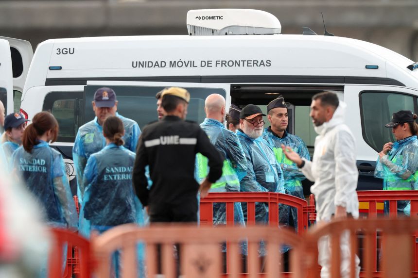 Security and health officials operate at the port of Granadilla de Abona following the arrival of the cruise ship MV Hondius after being affected by a hantavirus outbreak, in Tenerife, Spain, on May 10, 2026.